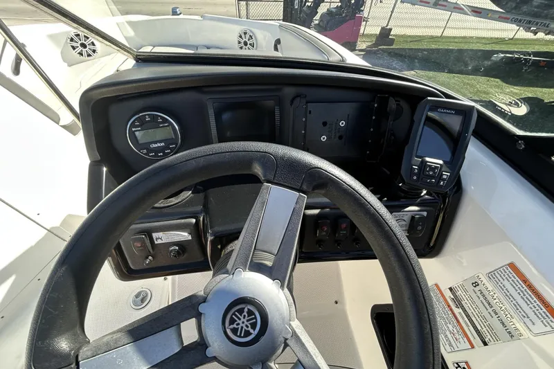 Slide: The Image of 2019 Yamaha Boats SX190 dashboard with steering wheel and navigation controls. - 16
