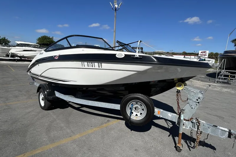 Slide: The Image of 2019 Yamaha Boats SX190 on trailer under clear blue sky. - 2