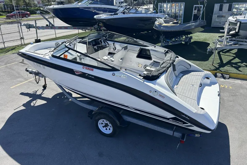 Slide: The Image of 2019 Yamaha Boats SX190 on trailer, parked in a marina lot. - 20