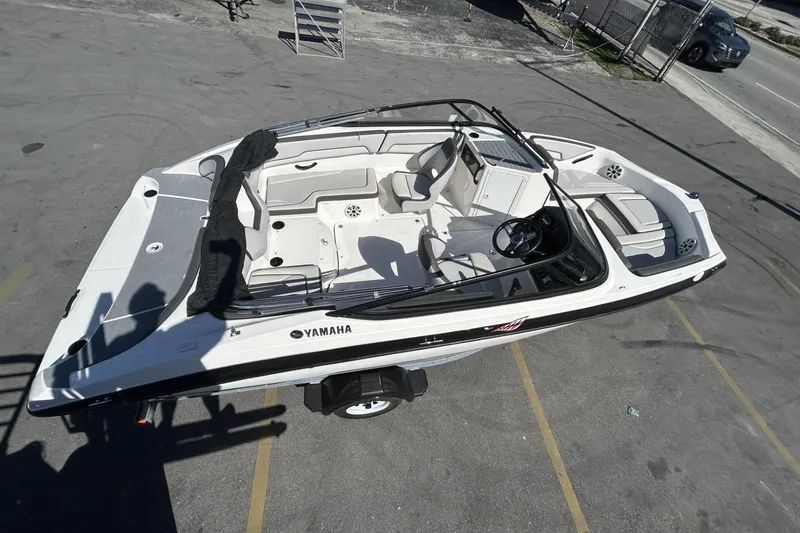 Slide: The Image of 2019 Yamaha Boats SX190, white, aerial view, parked on pavement. - 22