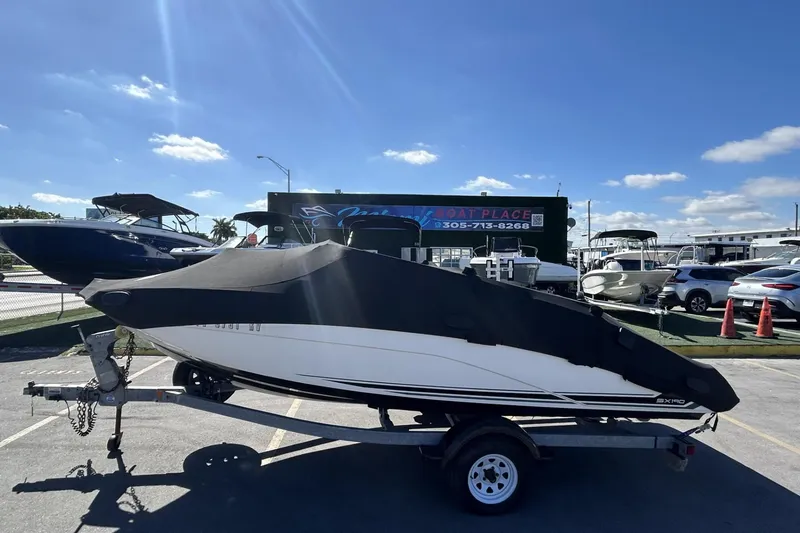 Slide: The Image of 2019 Yamaha Boats SX190 on trailer, covered, in sunny dealership lot. - 31