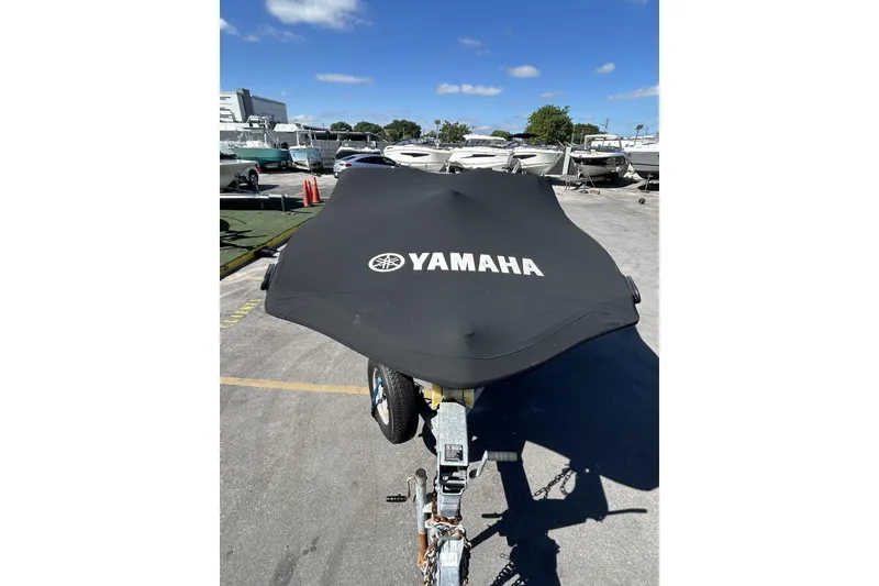 Slide: The Image of 2019 Yamaha SX190 boat with cover on trailer in sunny marina. - 32