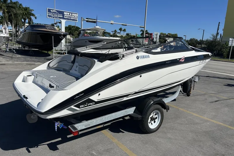 Slide: The Image of 2019 Yamaha Boats SX190 on trailer at dealership, sunny day. - 8