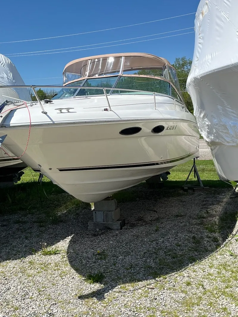 The Image of 1996 Sea Ray 280 Sun Sport boat on dry dock, sunny day, clear blue sky. - 0