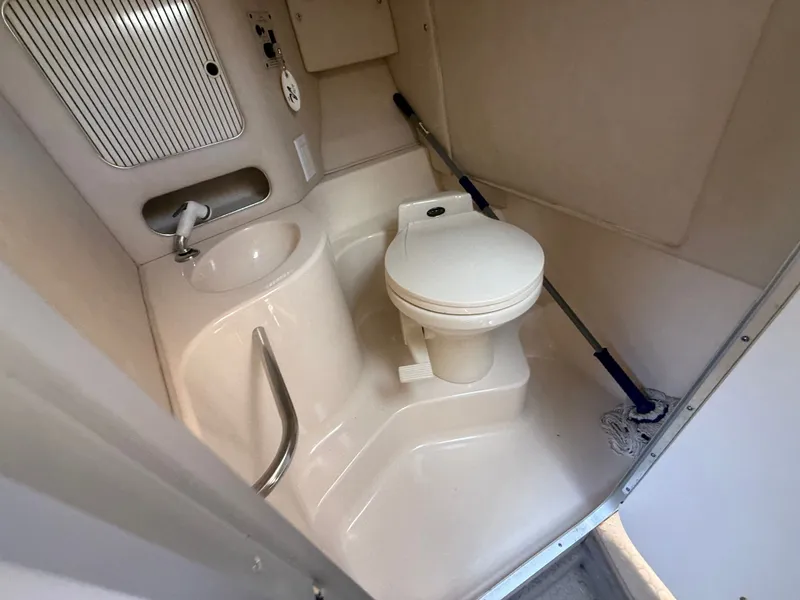 Slide: The Image of 1996 Sea Ray 280 Sun Sport boat bathroom with toilet and sink. - 13