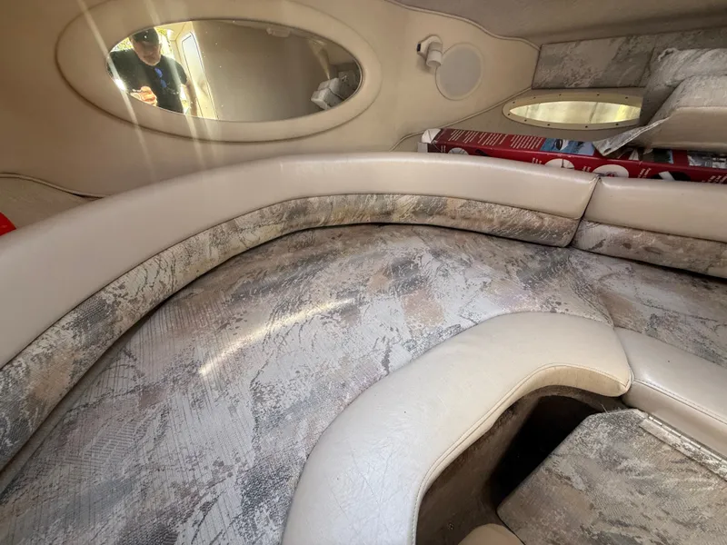 Slide: The Image of Interior of a 1996 Sea Ray 280 Sun Sport boat with cushioned seating. - 14