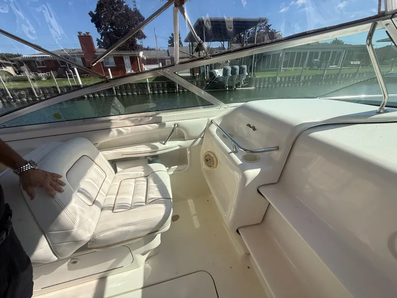 Slide: The Image of 1996 Sea Ray 280 Sun Sport boat interior with white seating and dashboard. - 17