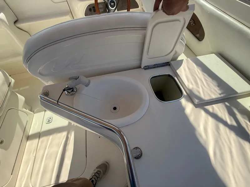 Slide: The Image of Interior of a 1996 Sea Ray 280 Sun Sport boat with sink and storage compartment. - 20