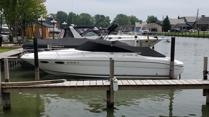 Slide: The Image of 1996 Sea Ray 280 Sun Sport docked at a marina with other boats. - 3