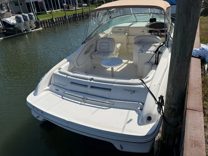 Slide: The Image of 1996 Sea Ray 280 Sun Sport boat docked, featuring spacious seating and sleek design. - 4