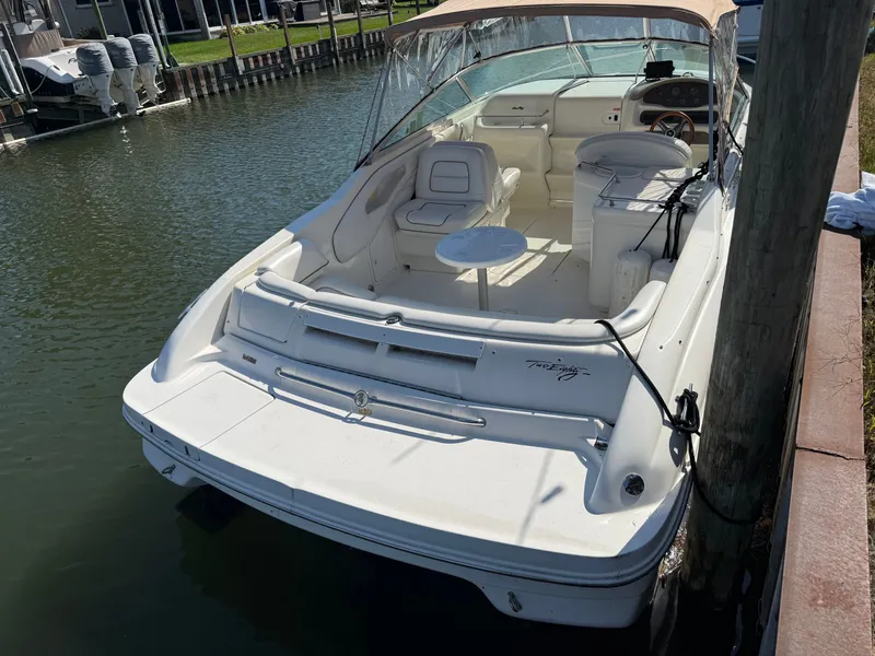 Slide: The Image of 1996 Sea Ray 280 Sun Sport boat docked, featuring spacious seating and sleek design. - 5