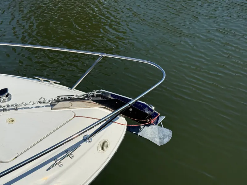 Slide: The Image of Bow of 1996 Sea Ray 280 Sun Sport with anchor and chain on calm water. - 6