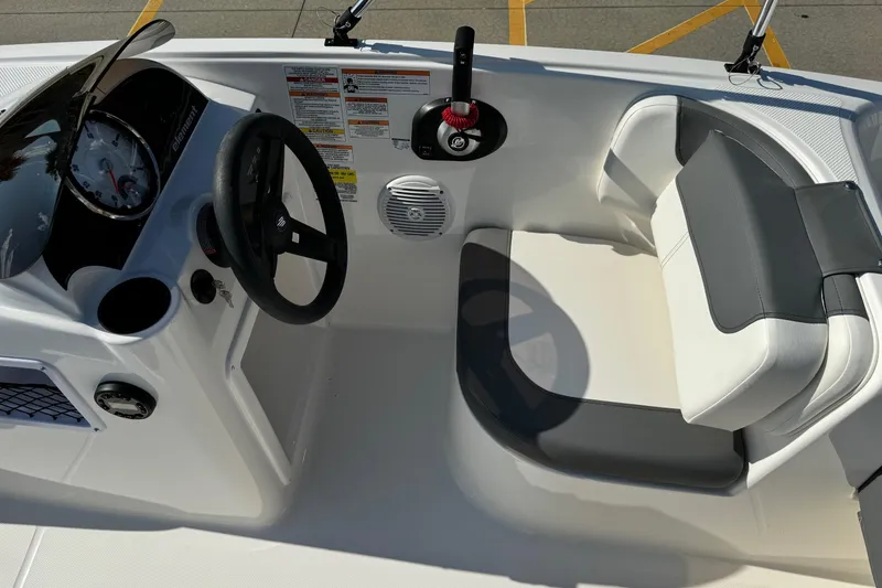 Slide: The Image of 2025 Bayliner Element E16 boat interior with steering wheel and seating area. - 11