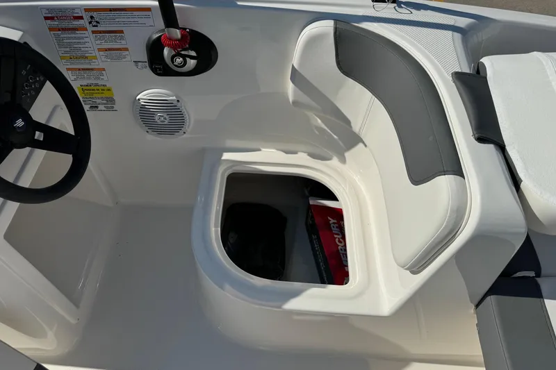 Slide: The Image of 2025 Bayliner Element E16 boat interior with steering wheel and storage compartment. - 15