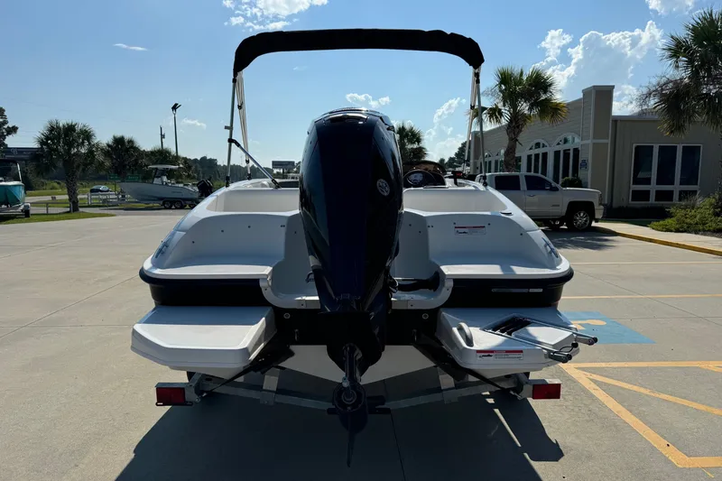 Slide: The Image of 2025 Bayliner Element E16 boat on trailer, parked outdoors under sunny sky. - 4