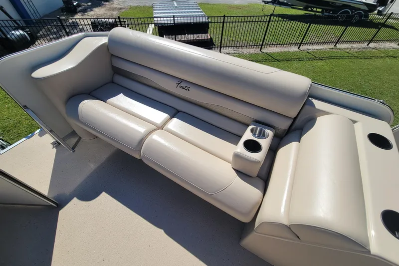 Slide: The Image of 2022 Fiesta 22' Fundeck L Sofa RE Deluxe with beige seating and cup holders. - 10