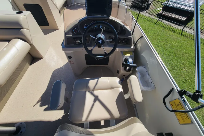 Slide: The Image of 2022 Fiesta Fundeck boat interior with steering wheel and beige seating. - 15