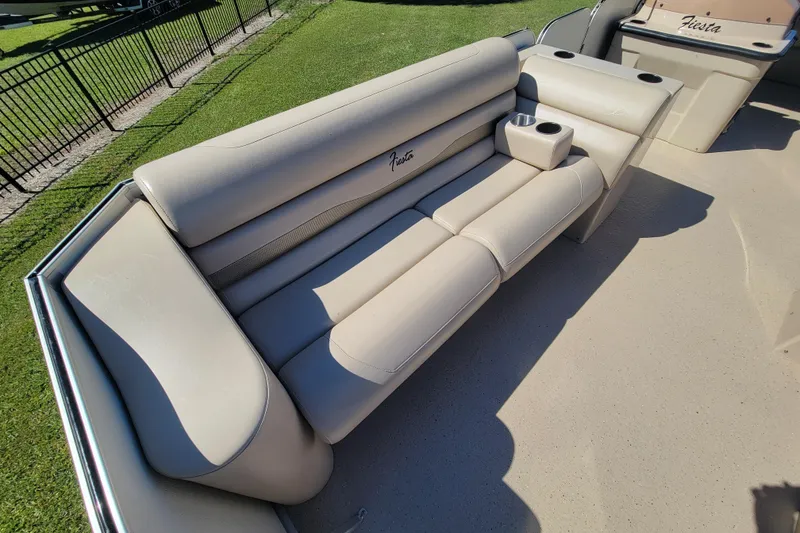Slide: The Image of 2022 Fiesta 22' Fundeck L Sofa RE Deluxe with beige seating and cup holders. - 8
