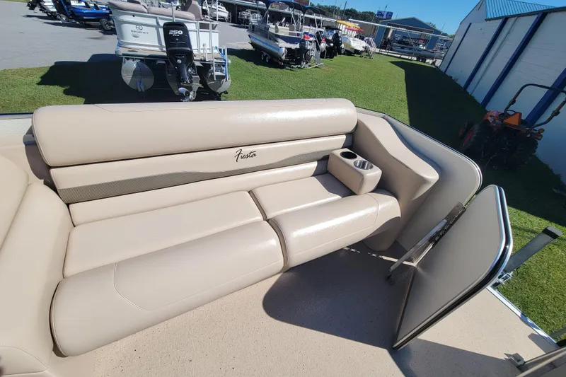 Slide: The Image of 2022 Fiesta 22' Fundeck L Sofa RE Deluxe with beige seating and cup holder. - 9