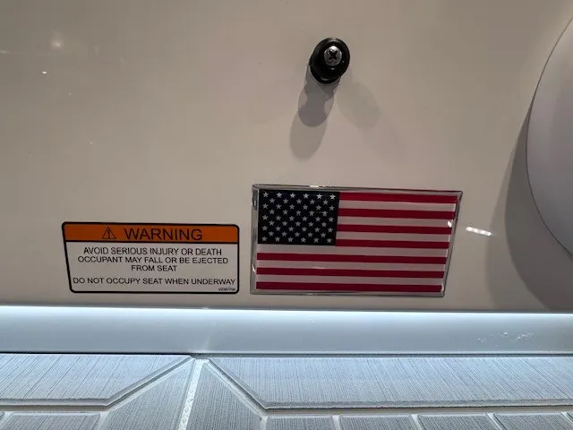 Slide: The Image of A warning label and an American flag are affixed to a boat. - 33
