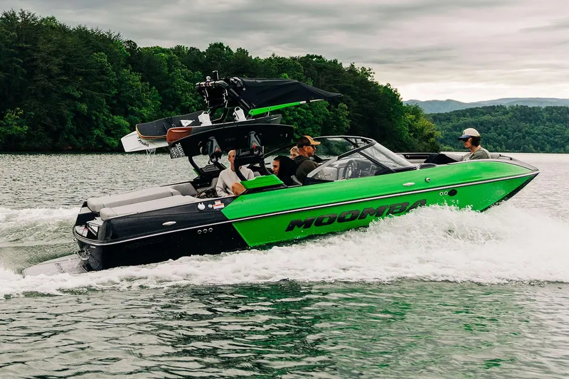 The Image of Manufacturer Provided Image: 2026 Moomba Mondo boat cruising on a lake with passengers, surrounded by lush greenery. - 0