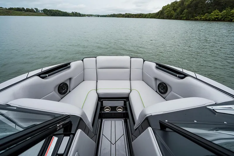 Slide: The Image of Manufacturer Provided Image: 2026 Moomba Mondo boat interior with plush seating on a serene lake. - 2