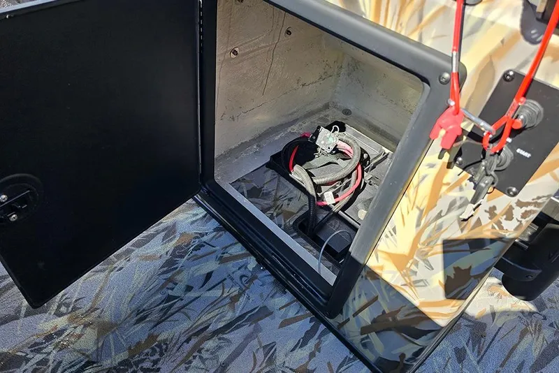 Slide: The Image of Open storage compartment in 2026 Ranger RB190 boat, featuring wiring and camouflage design. - 17