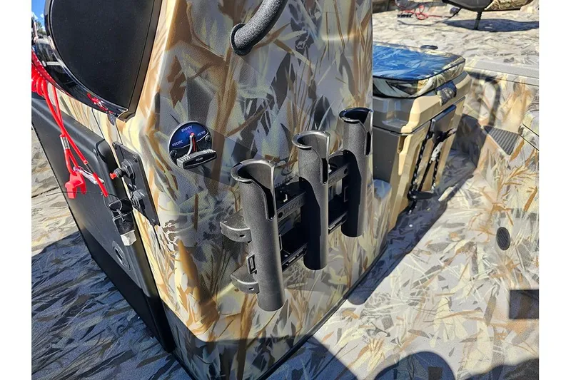Slide: The Image of 2026 Ranger RB190 boat interior with camouflage design and rod holders. - 19