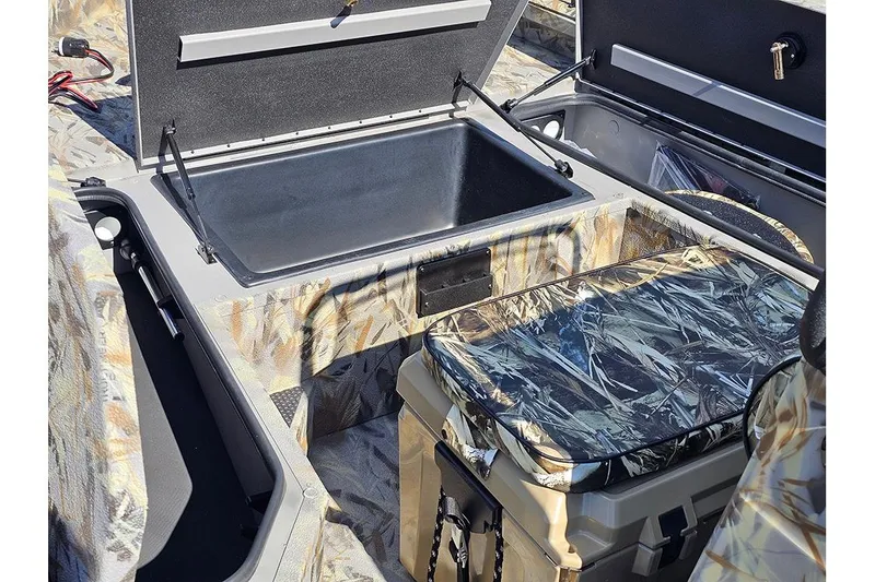 Slide: The Image of 2026 Ranger RB190 boat interior with open storage compartments and camouflage design. - 21