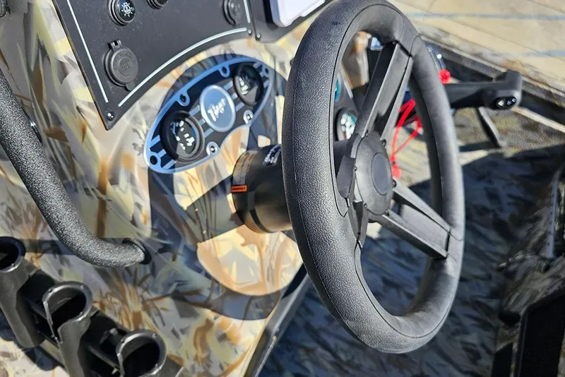 Slide: The Image of Steering wheel and dashboard of 2026 Ranger RB190 boat with camouflage design. - 25