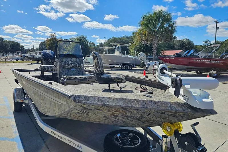 Slide: The Image of 2026 Ranger RB190 boat on trailer, camo design, parked outdoors under blue sky. - 5