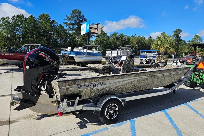Slide: The Image of 2026 Ranger RB190 boat with camouflage design on a trailer, parked outdoors. - 7