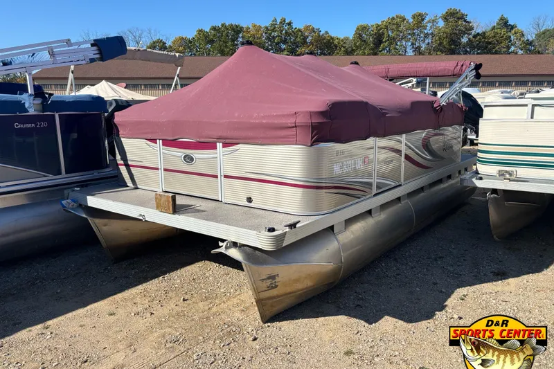 Slide: The Image of 2019 Qwest Edge 816 CR pontoon boat with maroon cover, parked outdoors. - 10