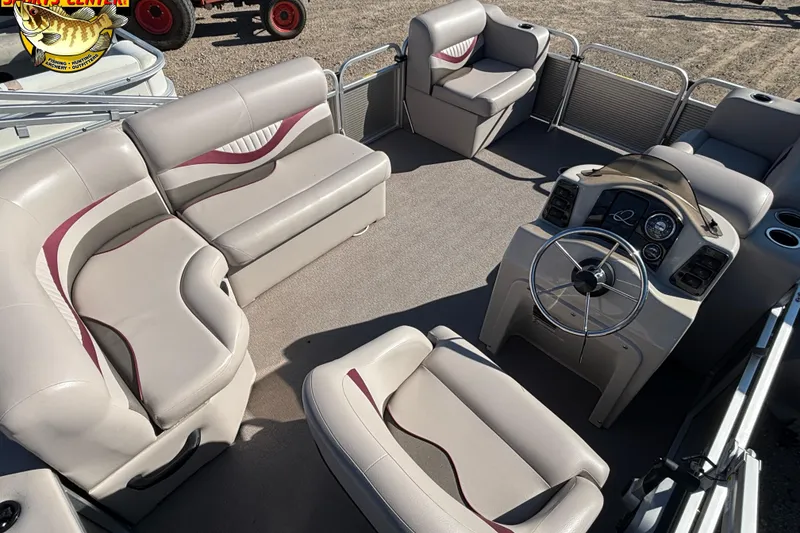 Slide: The Image of 2019 Qwest Edge 816 CR pontoon boat interior with plush seating and steering console. - 7