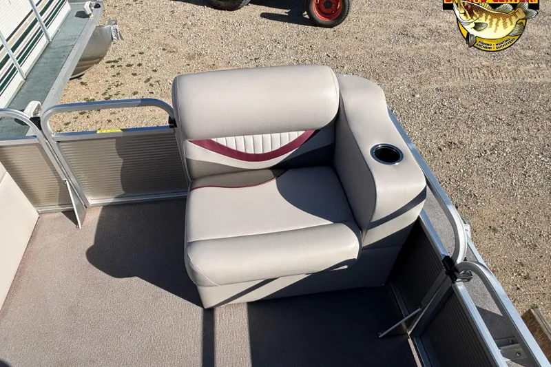 Slide: The Image of 2019 Qwest Edge 816 CR boat seat with cup holder, beige upholstery, outdoor setting. - 9