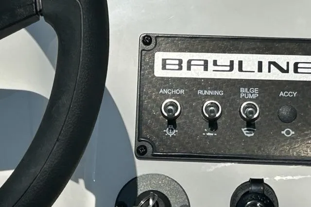 Slide: The Image of Control panel of 2026 Bayliner M17 boat with steering wheel and switches. - 13