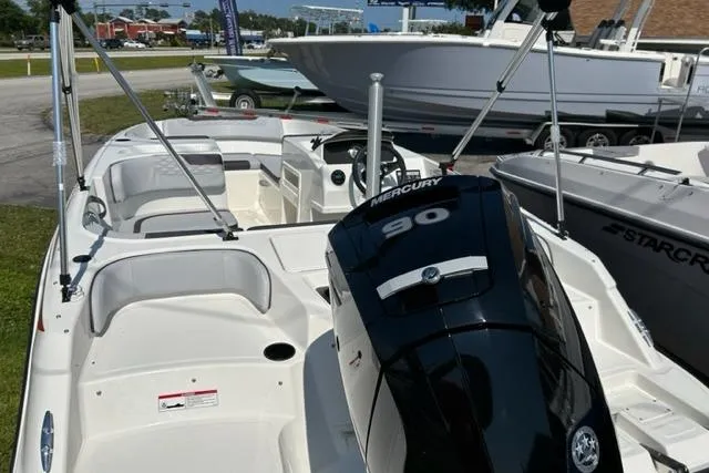 Slide: The Image of 2026 Bayliner M17 boat with Mercury 90 engine, displayed outdoors. - 9