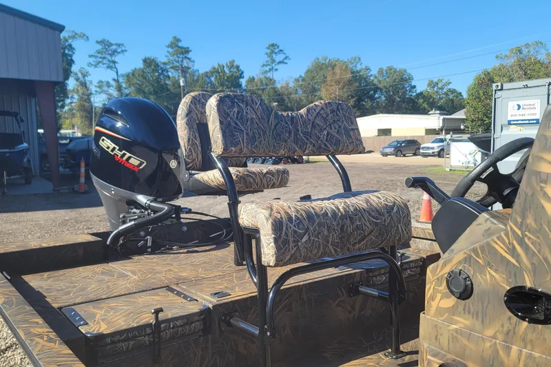 Slide: The Image of 2026 G3 Bay 21 GX Tunnel boat with camo seats and powerful outboard motor. - 12