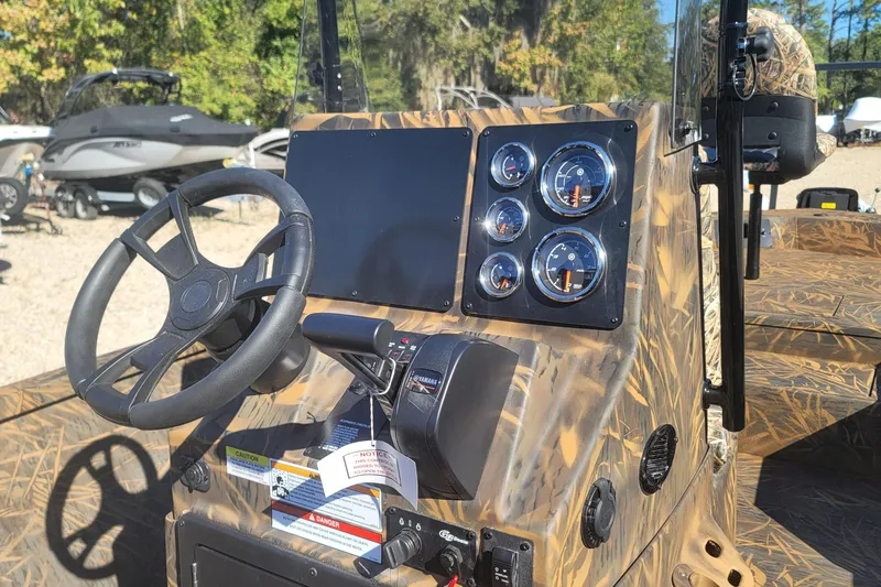 Slide: The Image of Steering console of 2026 G3 Bay 21 GX Tunnel boat with gauges and controls. - 13