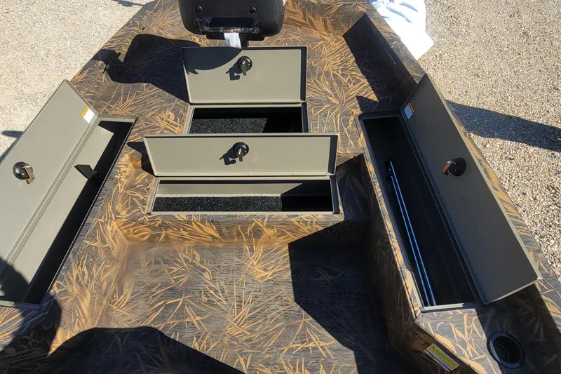 Slide: The Image of 2026 G3 Bay 21 GX Tunnel boat storage compartments with camo design, open for viewing. - 17