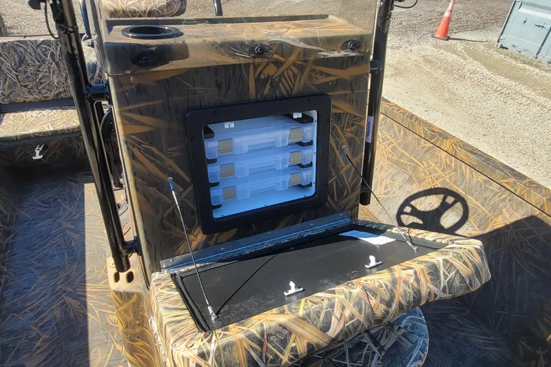 Slide: The Image of 2026 G3 Bay 21 GX Tunnel boat interior with camouflage design and storage compartment. - 19