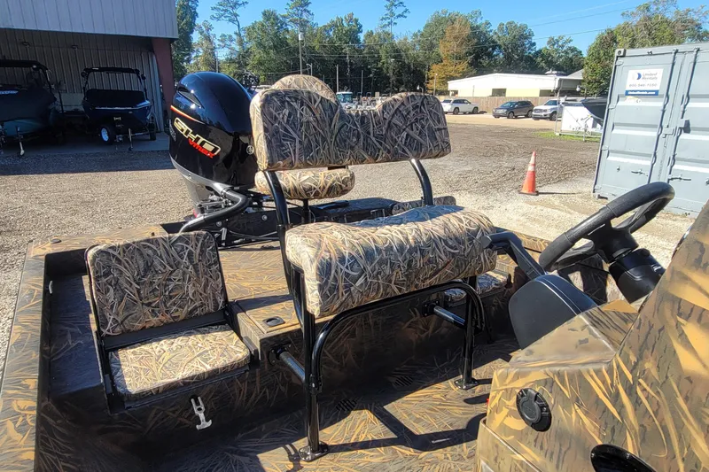 Slide: The Image of 2026 G3 Bay 21 GX Tunnel boat with camo seats and powerful outboard motor. - 20