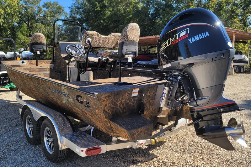 Slide: The Image of 2026 G3 Bay 21 GX Tunnel boat with Yamaha engine on trailer, outdoors. - 4