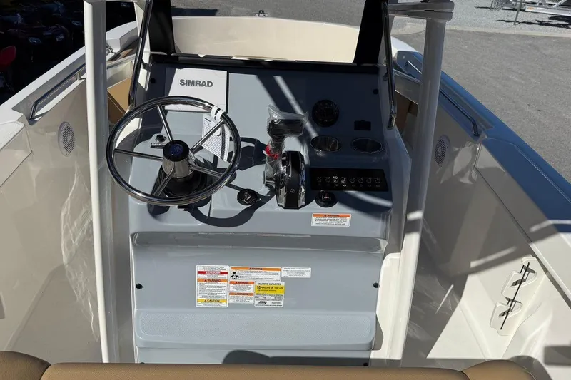 Slide: The Image of 2026 Bayliner Trophy T22CC boat console with steering wheel and controls. - 17