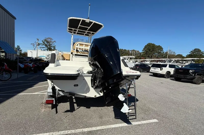 Slide: The Image of 2026 Bayliner Trophy T22CC boat with outboard motor in a parking lot. - 7
