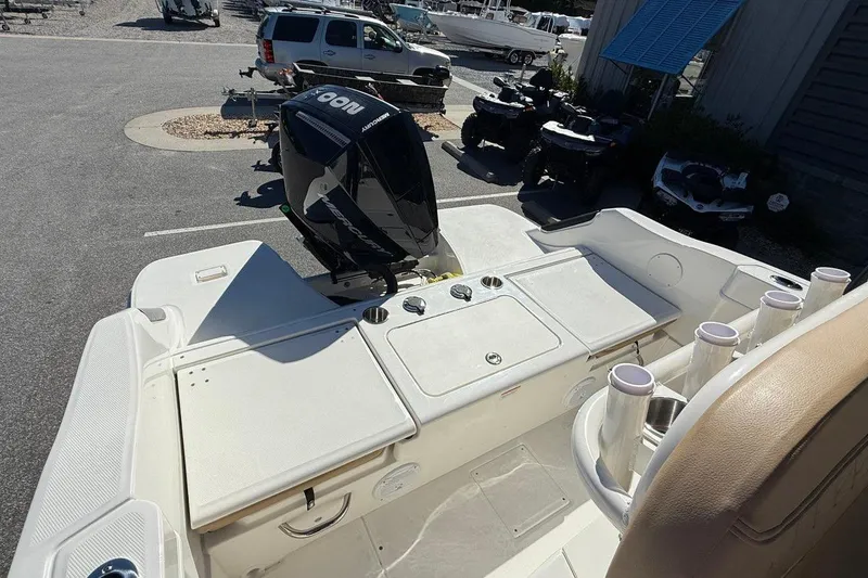 Slide: The Image of 2026 Bayliner Trophy T22CC boat with outboard motor in a parking lot. - 9