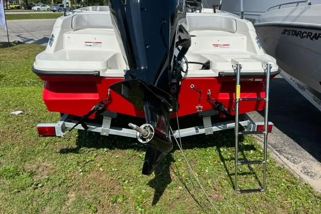 Slide: The Image of Bayliner M17 2026 boat on trailer, rear view with outboard motor and ladder. - 5