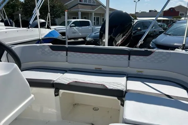 Slide: The Image of 2026 Bayliner M17 boat interior with cushioned seating and Mercury outboard motor. - 6