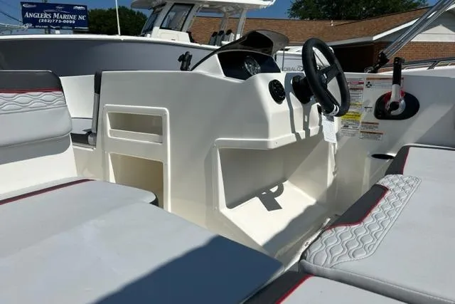 Slide: The Image of 2026 Bayliner M17 boat interior with steering wheel and seating, showcasing modern design. - 7