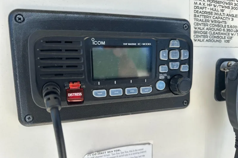 Slide: The Image of VHF marine radio on 2015 Sailfish 240 CC boat dashboard. - 10